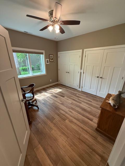 6207 Lagoon Dr NE, Bemidji, MN 56601 - unfurnished office with ceiling fan, wood finished floors, and baseboards