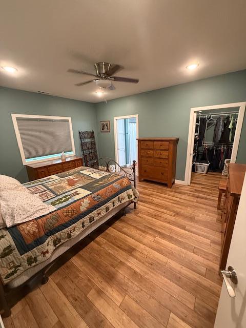 6207 Lagoon Dr NE, Bemidji, MN 56601 - bedroom with light wood-style flooring, a walk in closet, a ceiling fan, and recessed lighting