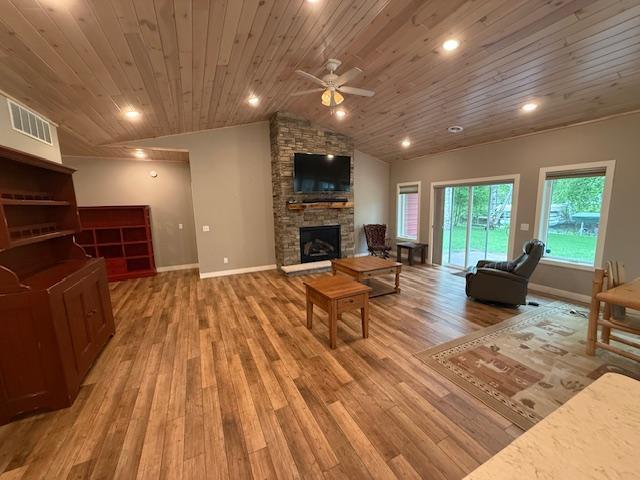 6207 Lagoon Dr NE, Bemidji, MN 56601 - living area with a fireplace, wooden ceiling, light wood finished floors, vaulted ceiling, and ceiling fan