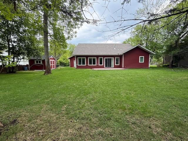 6207 Lagoon Dr NE, Bemidji, MN 56601 - rear view of property with a lawn