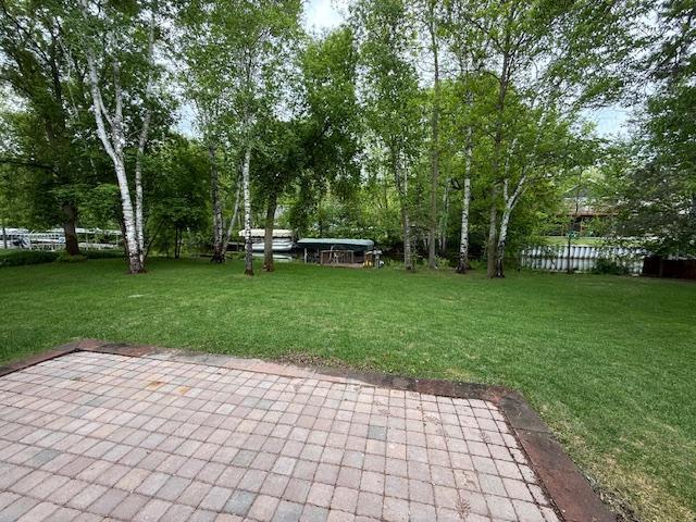 6207 Lagoon Dr NE, Bemidji, MN 56601 - view of grassy yard with a patio area