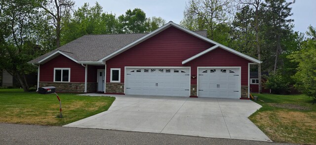 6207 Lagoon Dr NE, Bemidji, MN 56601 - single story home with a garage, stone siding, driveway, and a front lawn