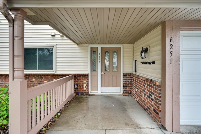 6251 Magda Dr Unit B, Maple Grove, MN 55369 - doorway to property with covered porch and brick siding