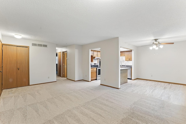 6251 Magda Dr Unit B, Maple Grove, MN 55369 - unfurnished living room featuring light colored carpet, a ceiling fan, baseboards, and a textured ceiling