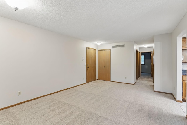 6251 Magda Dr Unit B, Maple Grove, MN 55369 - spare room featuring light colored carpet, baseboards, and a textured ceiling