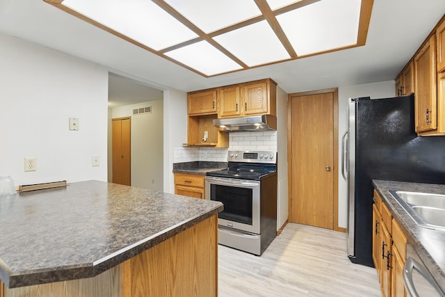 6251 Magda Dr Unit B, Maple Grove, MN 55369 - kitchen featuring appliances with stainless steel finishes, under cabinet range hood, dark countertops, light wood finished floors, and brown cabinetry
