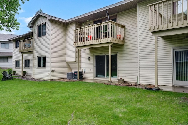 6251 Magda Dr Unit B, Maple Grove, MN 55369 - rear view of house with a balcony, a lawn, and central AC unit