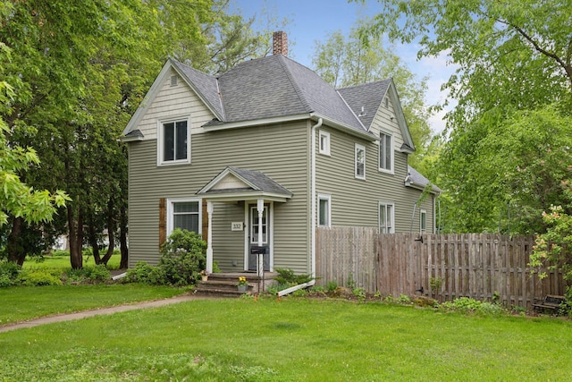 332 2nd St, New Richmond, WI 54017 - traditional home featuring a shingled roof and a chimney