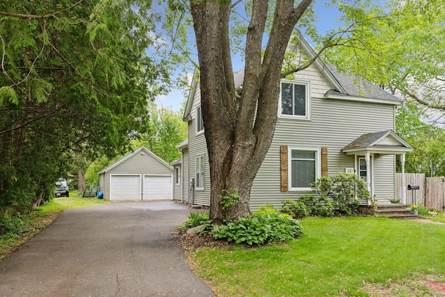 332 2nd St, New Richmond, WI 54017 - view of front of property featuring an outbuilding, a detached garage, a front lawn, and a shingled roof