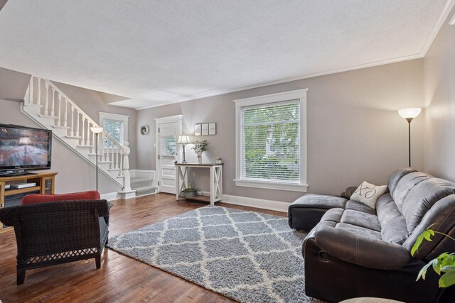 332 2nd St, New Richmond, WI 54017 - living area featuring stairway, healthy amount of natural light, wood finished floors, a textured ceiling, and baseboards