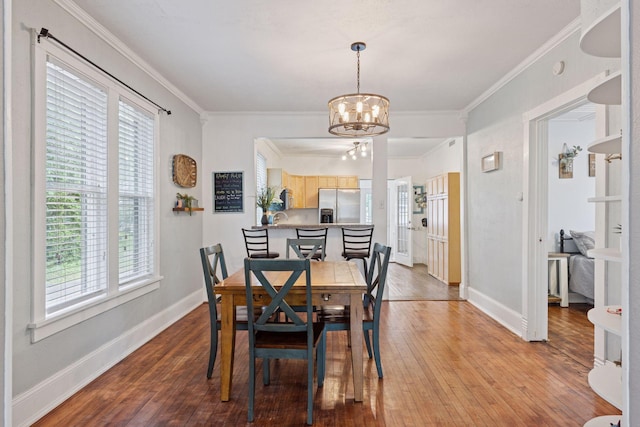 332 2nd St, New Richmond, WI 54017 - dining room with a chandelier, plenty of natural light, light wood finished floors, crown molding, and baseboards