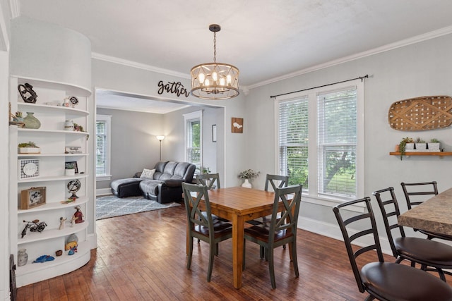 332 2nd St, New Richmond, WI 54017 - dining room featuring dark wood-type flooring, a chandelier, crown molding, and baseboards