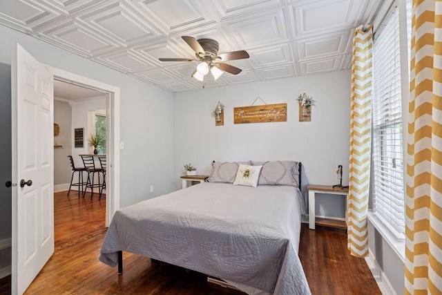 332 2nd St, New Richmond, WI 54017 - bedroom featuring an ornate ceiling, wood finished floors, baseboards, and a ceiling fan