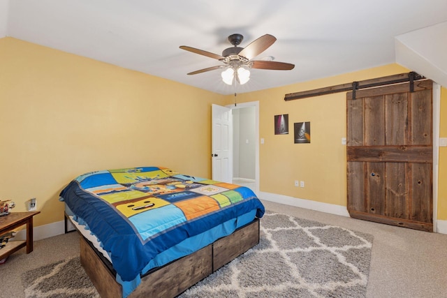 332 2nd St, New Richmond, WI 54017 - carpeted bedroom with a barn door, baseboards, and ceiling fan