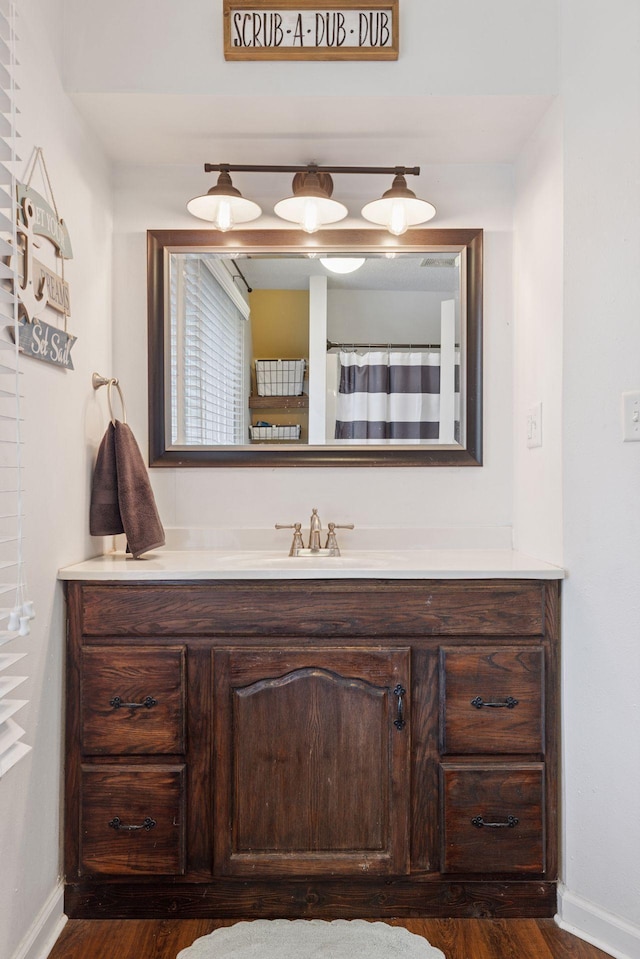 332 2nd St, New Richmond, WI 54017 - bathroom with vanity, baseboards, and wood finished floors