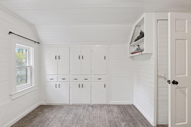 332 2nd St, New Richmond, WI 54017 - mudroom featuring carpet flooring, vaulted ceiling, and wooden walls