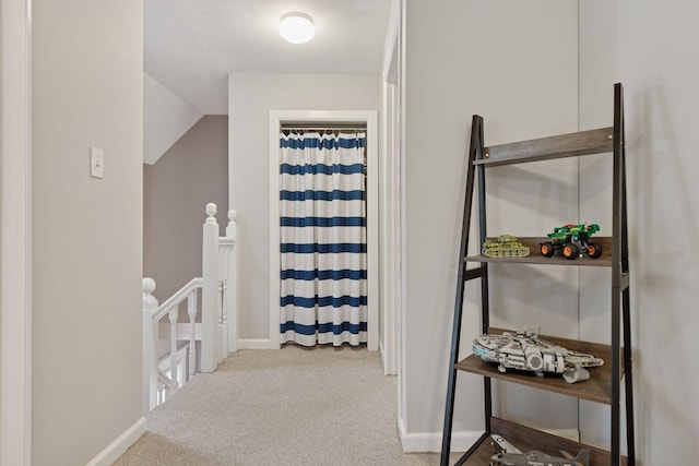 332 2nd St, New Richmond, WI 54017 - corridor with an upstairs landing, carpet, baseboards, and a textured ceiling