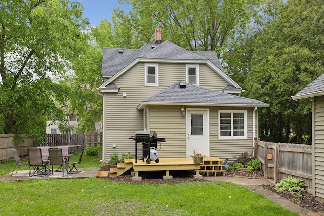 332 2nd St, New Richmond, WI 54017 - back of house with roof with shingles, a chimney, and a deck