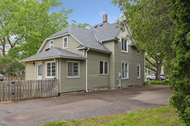 332 2nd St, New Richmond, WI 54017 - view of front of property with a shingled roof and a chimney