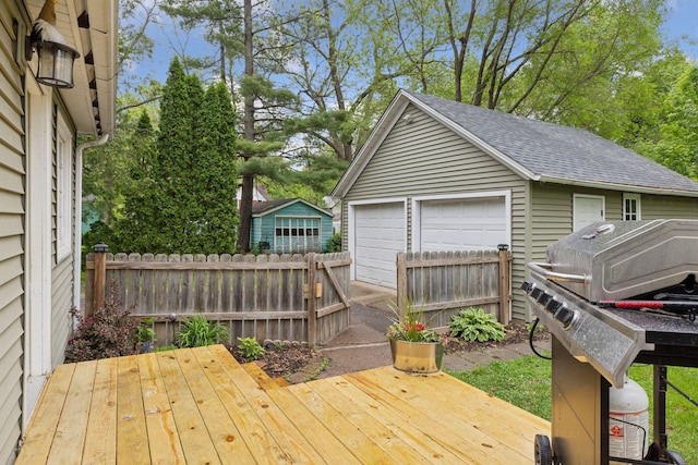 332 2nd St, New Richmond, WI 54017 - wooden terrace featuring a detached garage, grilling area, and an outdoor structure