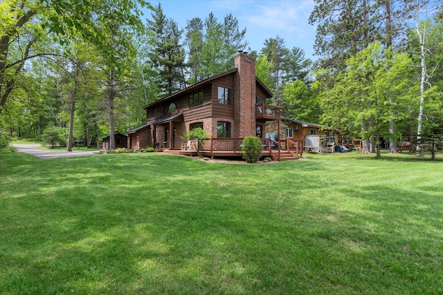 11690 Harbor Ln, Ideal Twp, MN 56442 - view of side of home with a chimney, a yard, and a deck