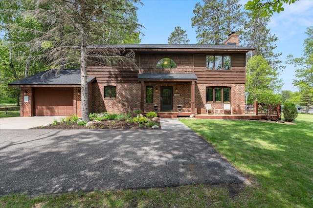 11690 Harbor Ln, Ideal Twp, MN 56442 - view of front of property with a chimney, driveway, brick siding, a garage, and a front yard