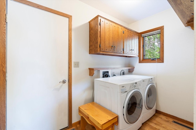 11690 Harbor Ln, Ideal Twp, MN 56442 - laundry room with cabinet space, independent washer and dryer, light wood-style flooring, and baseboards