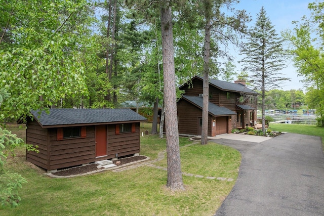 11690 Harbor Ln, Ideal Twp, MN 56442 - view of side of property with asphalt driveway, a garage, and a yard