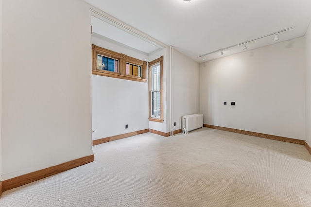 492 Dayton Ave, Saint Paul, MN 55102 - carpeted empty room featuring radiator and rail lighting