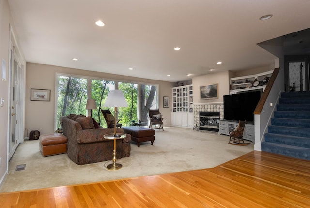 6323 Timber Trl, Edina, MN 55439 - living room featuring a tiled fireplace, recessed lighting, carpet floors, stairs, and baseboards