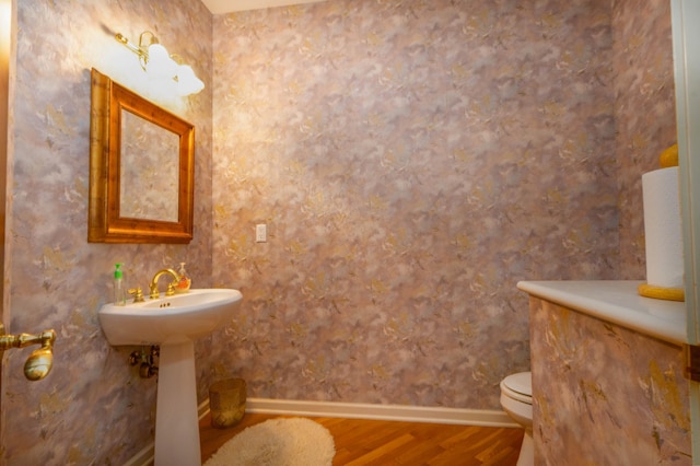 6323 Timber Trl, Edina, MN 55439 - half bath with wood finished floors, toilet, a sink, and baseboards