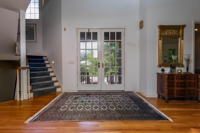 6323 Timber Trl, Edina, MN 55439 - foyer entrance with wood finished floors, french doors, stairs, a towering ceiling, and baseboards