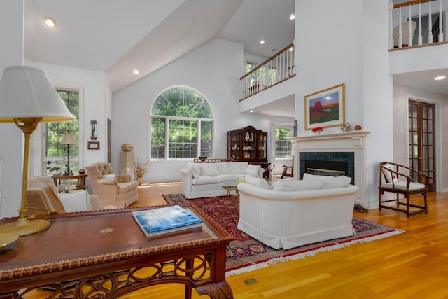 6323 Timber Trl, Edina, MN 55439 - living area with wood finished floors, healthy amount of natural light, a tile fireplace, high vaulted ceiling, and recessed lighting