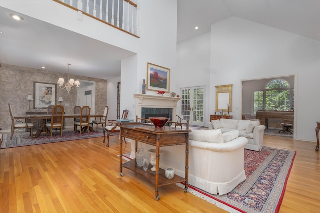 6323 Timber Trl, Edina, MN 55439 - living room with a tiled fireplace, wood finished floors, a chandelier, high vaulted ceiling, and recessed lighting