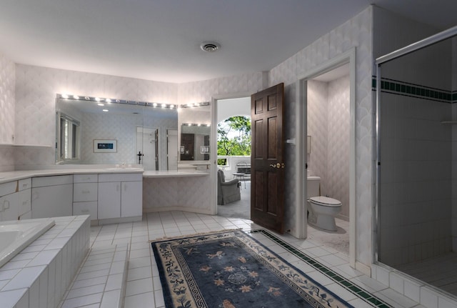 6323 Timber Trl, Edina, MN 55439 - bathroom featuring toilet, double vanity, tile patterned flooring, wallpapered walls, and a garden tub
