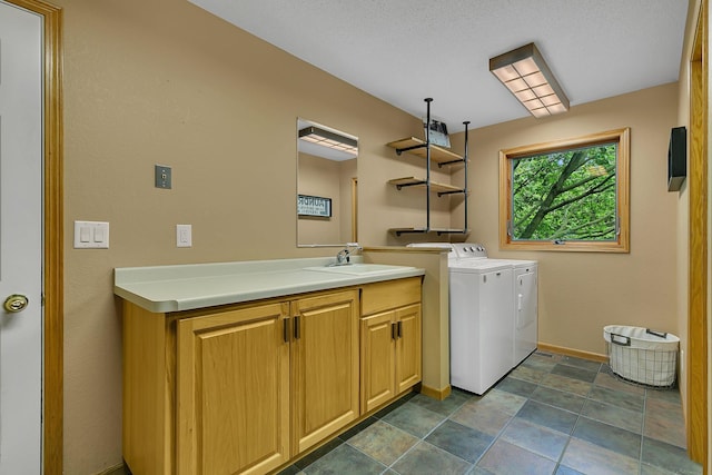 8081 45th Ave SW, Raymond, MN 56282 - laundry room with washing machine and dryer, cabinet space, baseboards, and dark stone finish floors
