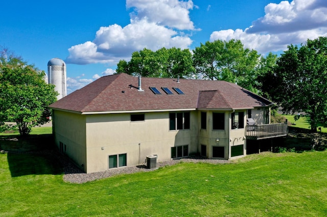 8081 45th Ave SW, Raymond, MN 56282 - rear view of property featuring roof with shingles, a lawn, cooling unit, and stucco siding
