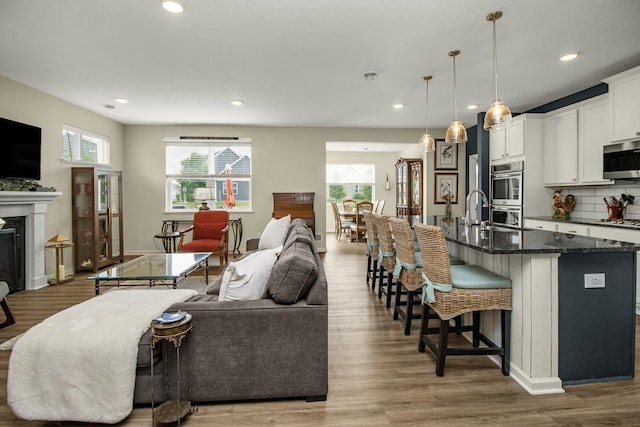 4745 Copper Cir, Woodbury, MN 55129 - living area featuring healthy amount of natural light, wood finished floors, recessed lighting, and a fireplace