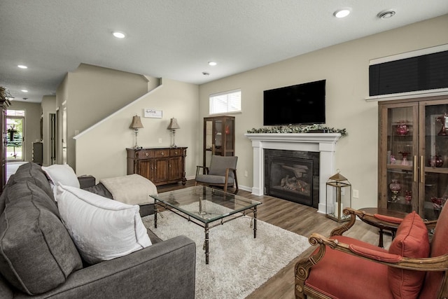 4745 Copper Cir, Woodbury, MN 55129 - living room with wood finished floors, a glass covered fireplace, and recessed lighting