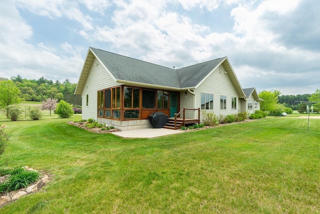 N12011 County Road Ss, Otter Creek Twp, WI 54772 - rear view of property featuring a shingled roof, a patio area, a yard, and a deck