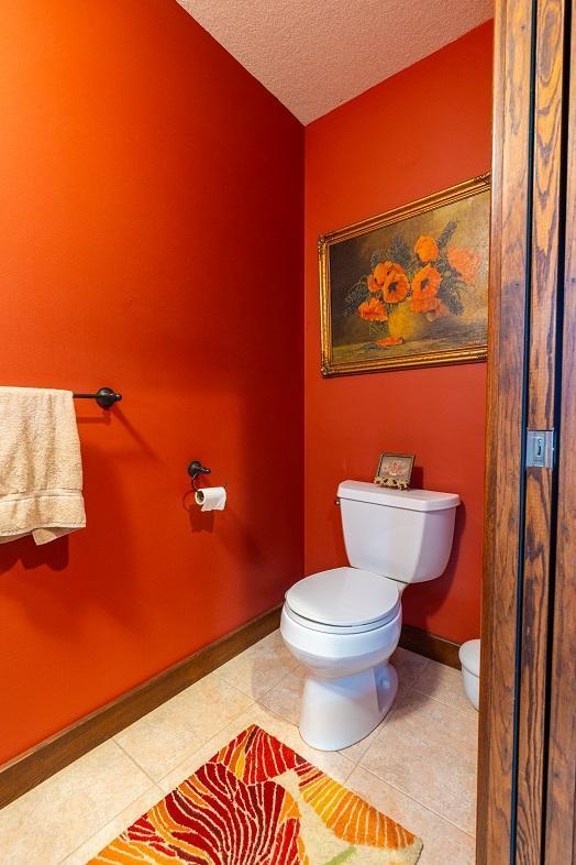 N12011 County Road Ss, Otter Creek Twp, WI 54772 - bathroom with toilet, a textured ceiling, tile patterned flooring, and baseboards