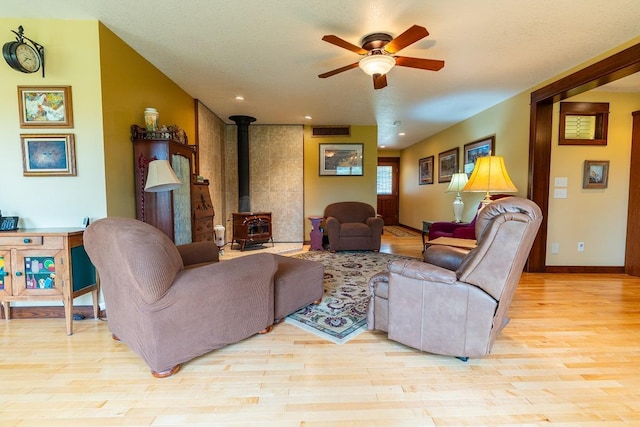 N12011 County Road Ss, Otter Creek Twp, WI 54772 - living area with a wood stove, ceiling fan, wood finished floors, recessed lighting, and baseboards