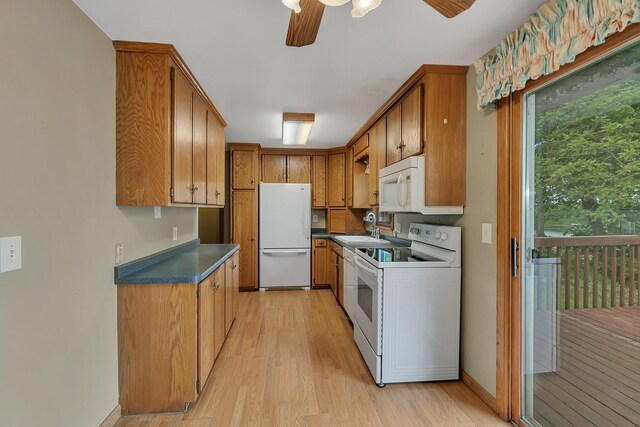 16736 County Road 49, Cold Spring, MN 56320 - kitchen with white appliances, light wood-type flooring, a sink, and dark countertops