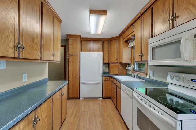 16736 County Road 49, Cold Spring, MN 56320 - kitchen with white appliances, a sink, brown cabinetry, and light wood finished floors