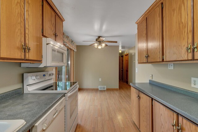 16736 County Road 49, Cold Spring, MN 56320 - kitchen featuring white appliances, a ceiling fan, light wood-type flooring, and brown cabinets