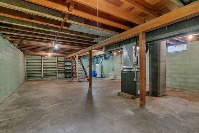 16736 County Road 49, Cold Spring, MN 56320 - basement with concrete block wall, heating unit, gas water heater, and stairs