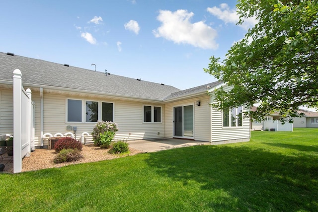 2475 Mossy Creek Dr NE, Owatonna, MN 55060 - rear view of house featuring a patio, a lawn, and roof with shingles
