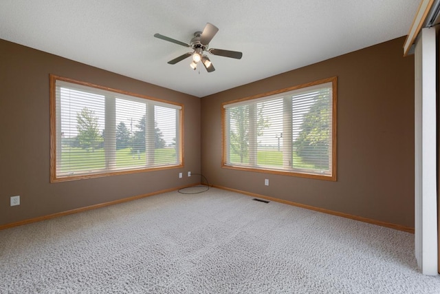 2475 Mossy Creek Dr NE, Owatonna, MN 55060 - carpeted spare room featuring baseboards and a ceiling fan