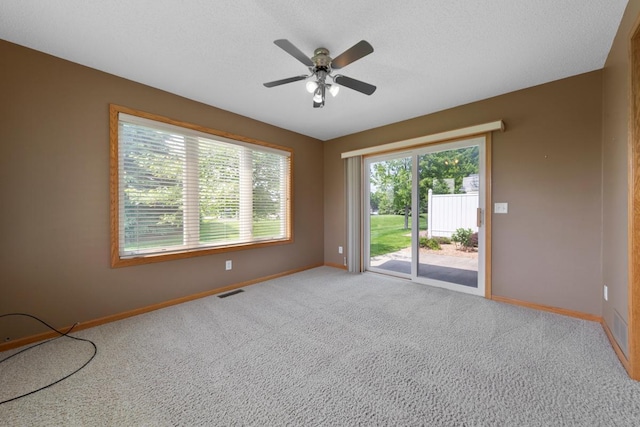 2475 Mossy Creek Dr NE, Owatonna, MN 55060 - spare room featuring carpet and ceiling fan