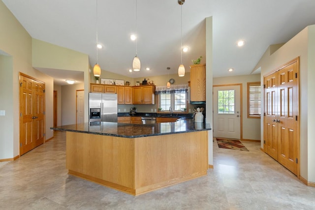 2475 Mossy Creek Dr NE, Owatonna, MN 55060 - kitchen featuring appliances with stainless steel finishes, lofted ceiling, dark stone counters, pendant lighting, and a peninsula